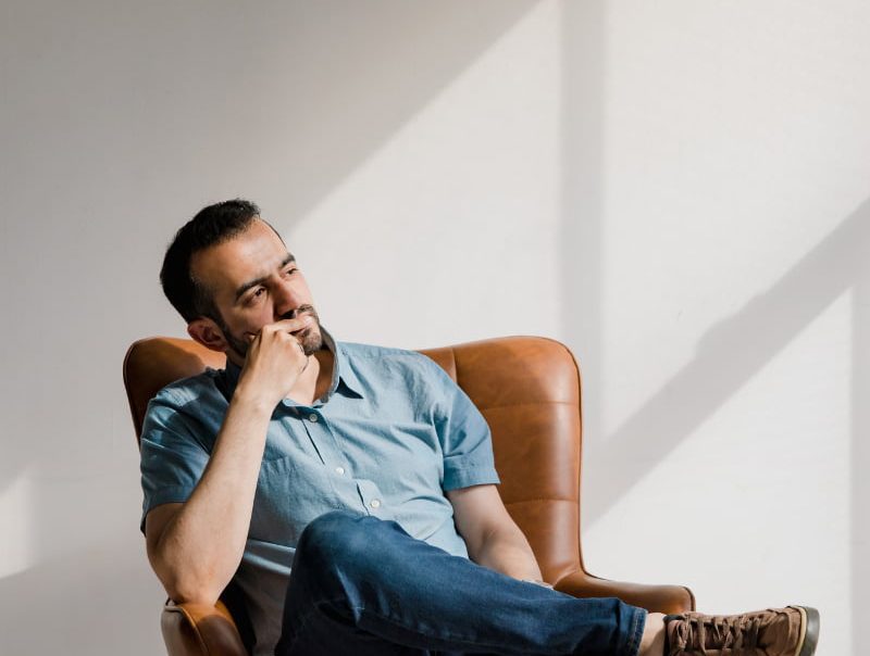 a man thinking on his chair